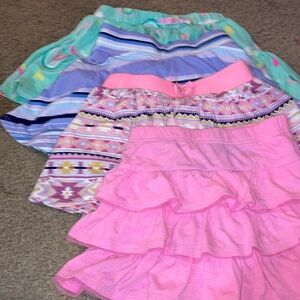 Set of 4 skirts with built in shorts size 5/6